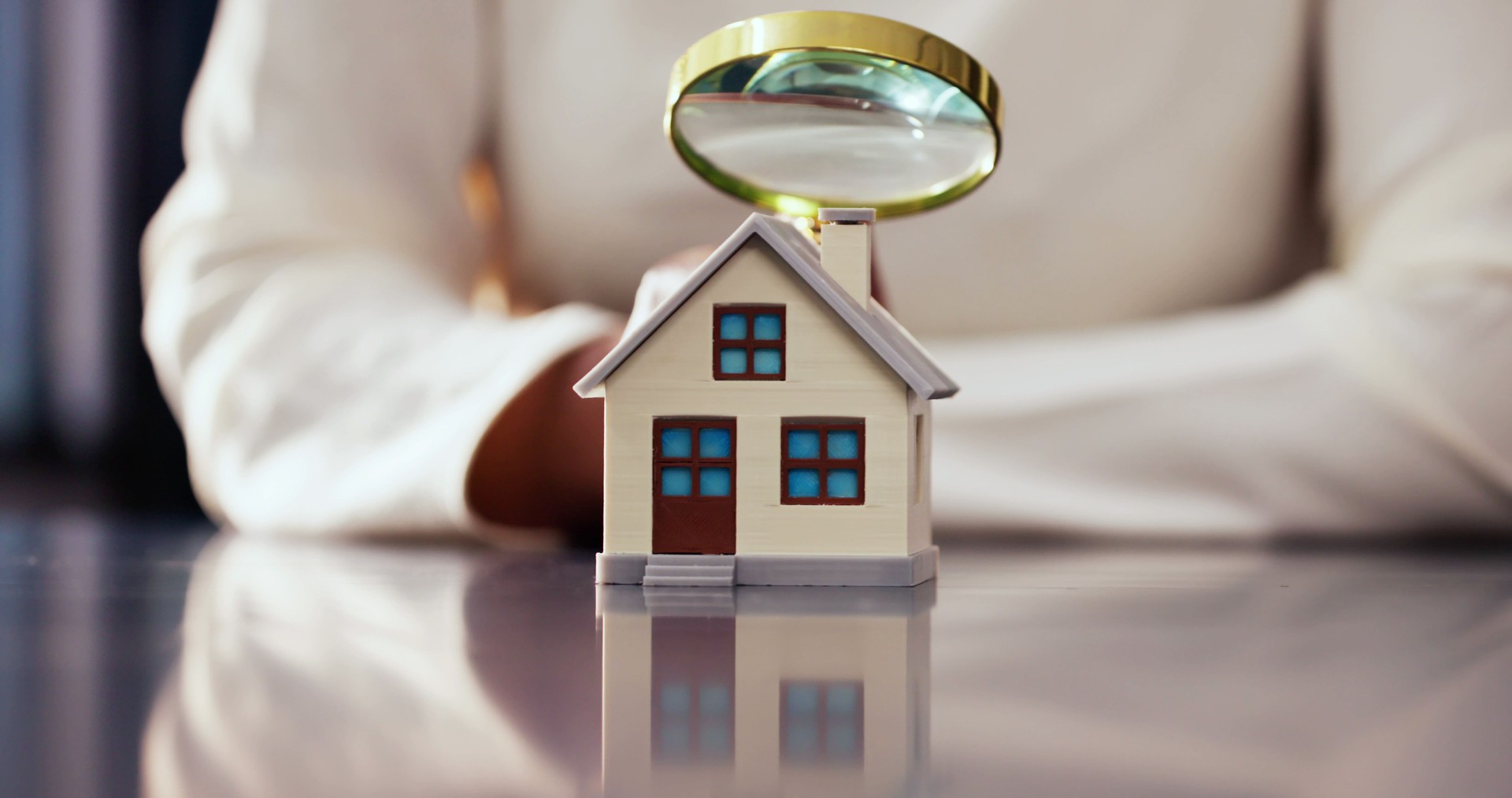 African-American Woman Inspecting House with Magnifying Glass for Real Estate Appraisal and Tax Assessment